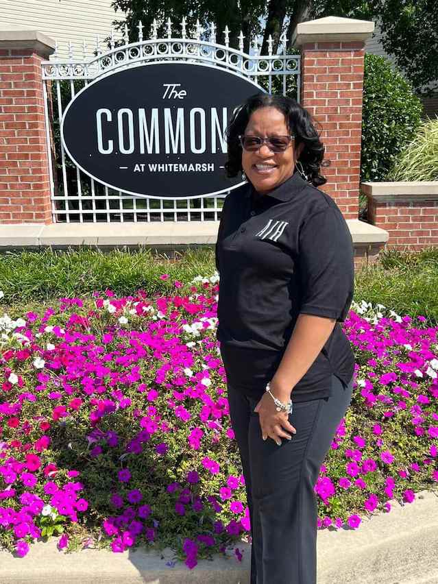 Rosalind in AJH uniform posing in front of Commons sign